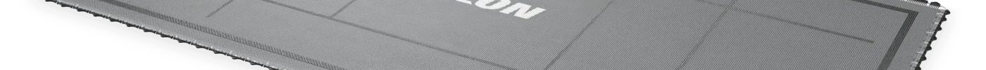 Schräg dargestellte ACON X Freestyle Trampolinmatte mit grauer Sprungfläche, schwarzen Markierungen und ACON Logo.